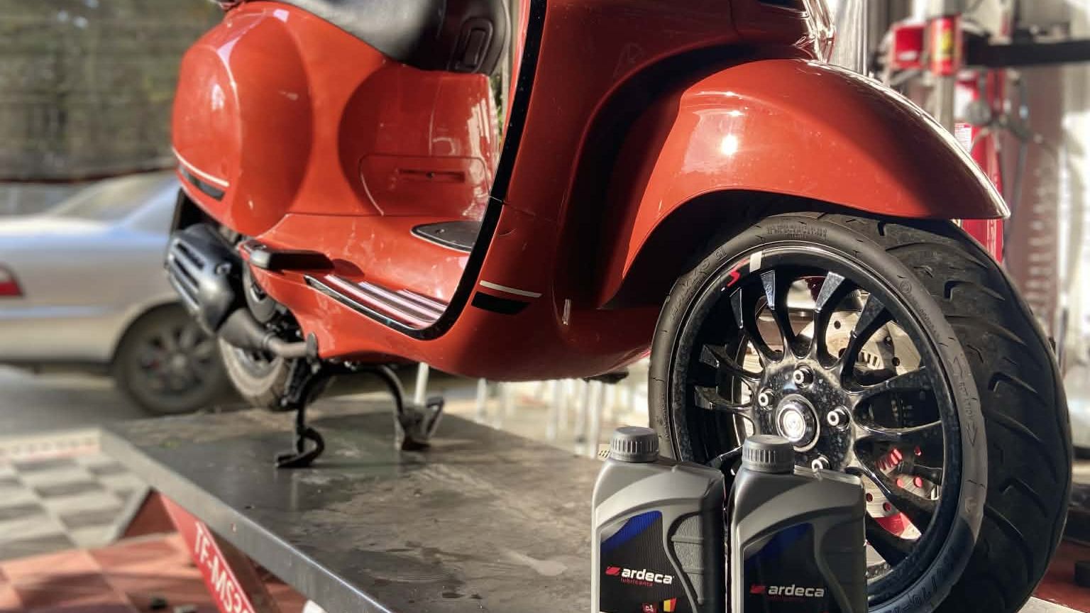 Orange Vespa on the MotoNorte service lift