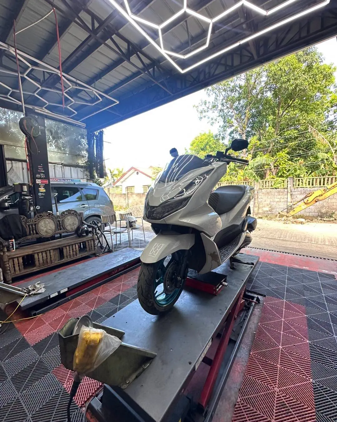 Honda PCX on the service lift at MotoNorte, Batac City