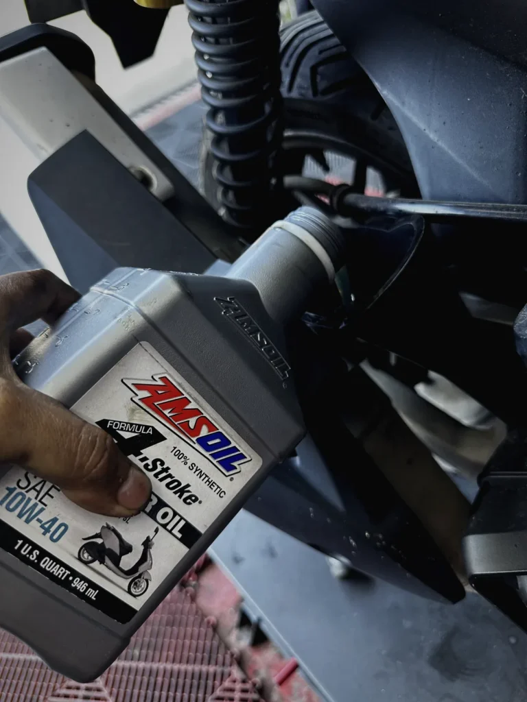 Fully synthetic oil being poured during an oil change at MotoNorte
