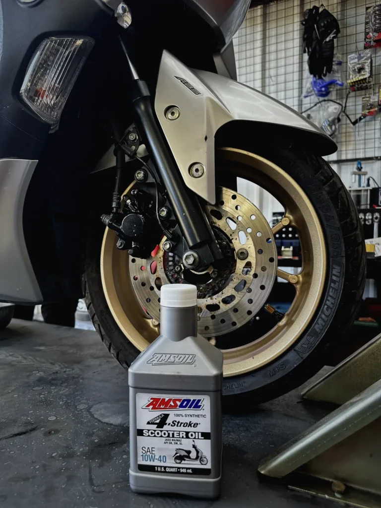 Yamaha NMAX on the service lift for PMS at MotoNorte with Amsoil oil