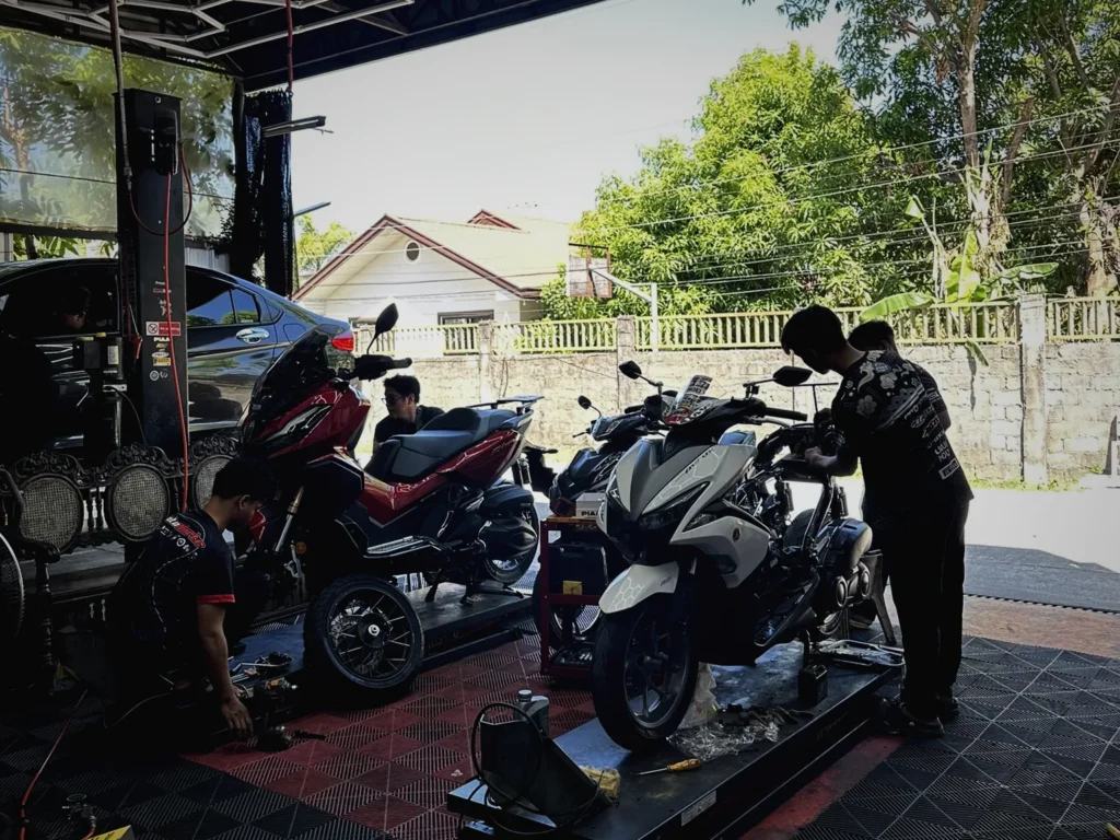 MotoNorte technicians servicing scooters on the lifts at the shop in Batac City, Ilocos Norte